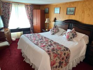 Tempat tidur dalam kamar di Hostal Español Coyhaique