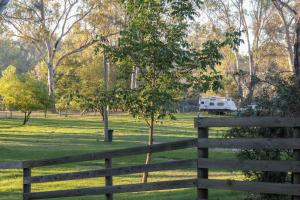 a green field with a fence and a fence post at BIG4 Seymour Holiday Park in Seymour