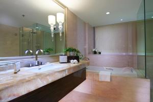 a bathroom with a tub and a sink and a shower at Dorsett Chengdu in Chengdu