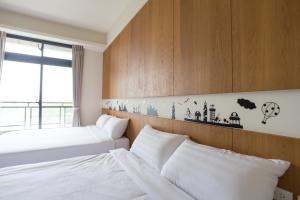 Postel nebo postele na pokoji v ubytování DoMo Yilan