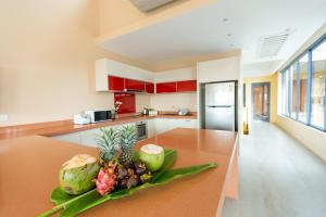 a kitchen with a table with a bowl of fruit on it at Teetara Villa Patong in Patong Beach