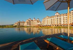 a view of a resort with chairs and an umbrella at Sunrise All Suites Resort- All Inclusive in Obzor