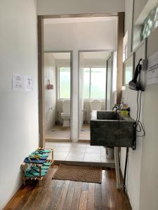 a bathroom with a sink and a toilet at Hornbill's Nest Kuching in Kuching