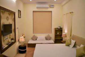 Ein Bett oder Betten in einem Zimmer der Unterkunft Ranthambore MAHÀL