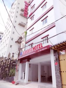 a building with a sign for a hotel at Aurora Hotel in Ho Chi Minh City +38 photos
