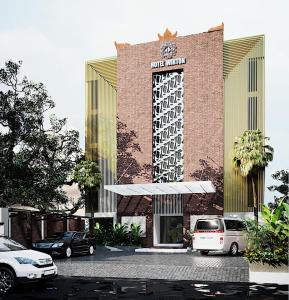 a building with cars parked in front of it at Wirton Seminyak in Denpasar