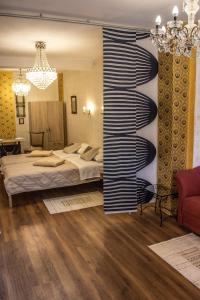a bedroom with a bed and a chandelier at Boki Apartmant in Subotica