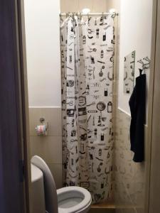 a bathroom with a shower curtain with asian writing on it at Комнаты у Московского вокзала in Saint Petersburg
