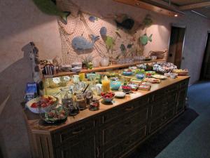 a buffet with food and drinks on a table at Gästehaus Ainser in Hagnau