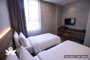 Postel nebo postele na pokoji v ubytování Ceria Hotel