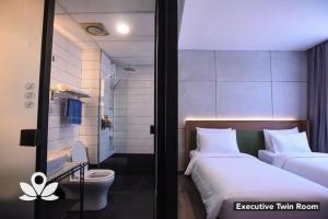 Postel nebo postele na pokoji v ubytování Ceria Hotel