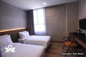 Postel nebo postele na pokoji v ubytování Ceria Hotel