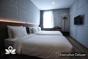 Postel nebo postele na pokoji v ubytování Ceria Hotel