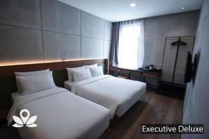 Postel nebo postele na pokoji v ubytování Ceria Hotel