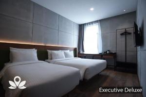 Postel nebo postele na pokoji v ubytování Ceria Hotel