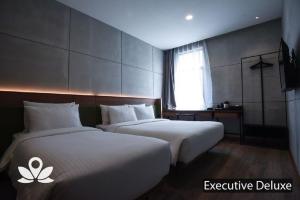 Postel nebo postele na pokoji v ubytování Ceria Hotel