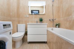 a bathroom with a toilet and a sink and a tub at Luxury apart-hotel near Lavina New Building 7 floor in Sumy +19 photos