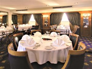 a dining room with a table with white table cloth at Jaz Crown Prince Nile Cruise - Every Monday from Luxor for 07 & 04 Nights - Every Friday From Aswan for 03 Nights in Luxor