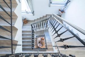 a man holding a dog looking up the stairs of a house at Apartments Mooshof in Neustift im Stubaital