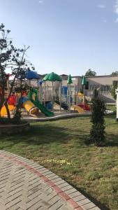 a park with a playground with slides at Rawaat Ghaym in Taif