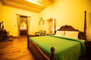 a bedroom with a bed and a chair in it at The Hive Cottage in Nainital