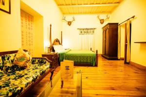 a bedroom with a bed and a desk at The Hive Cottage in Nainital
