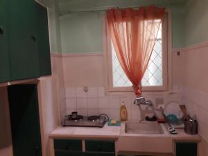 a kitchen with a sink and a window at By Lycabettus in the city-heart close to Acropolis in Athens