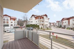 an apartment balcony with a view of a street at Grand Apartments - Neptun Park. in Gdańsk