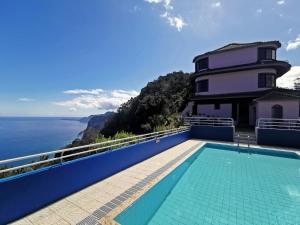 a house with a swimming pool overlooking the ocean at Santana in Nature Bed & Breakfast in Santana