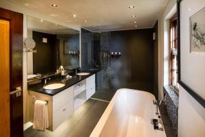 a bathroom with a sink and a bathtub at Grande Roche Hotel in Paarl
