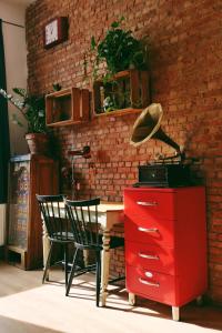 a desk with two chairs and a red dresser at 130sqm appartment with 20sqm terras and free parking in Antwerp