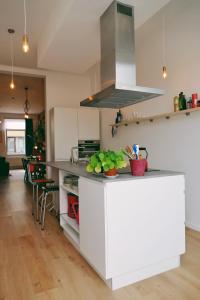 a kitchen with a white island with a counter top at 130sqm appartment with 20sqm terras and free parking in Antwerp