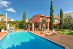 a swimming pool in front of a house at Villa Casa Del Sol with private pool in Sounio