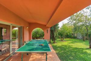 a ping pong table sitting inside of a house at Villa Casa Del Sol with private pool in Sounio
