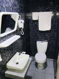 a bathroom with a white toilet and a sink at HARRYS RESIENDENCE in Bangkok +10 photos