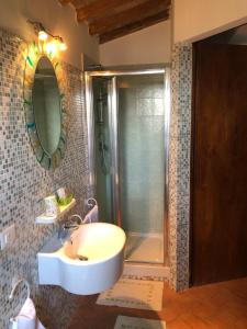 a bathroom with a sink and a shower at Agriturismo Specchio Del Lago in Montefiascone