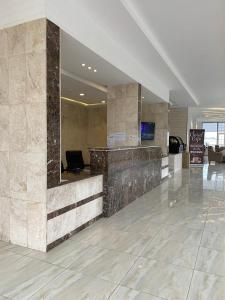 a lobby with a reception desk in a building at Rawaat Ghaym in Taif