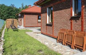a house with a bench next to a building at 2 Bedroom Lovely Home In Glowczyce in Główczyce