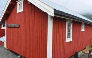 a red and white building with two windows at Two-Bedroom Holiday Home In Sorvagen in Sørvågen