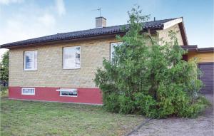 a house with a tree in front of it at Gorgeous Home In Hästveda With Kitchen in Hästveda