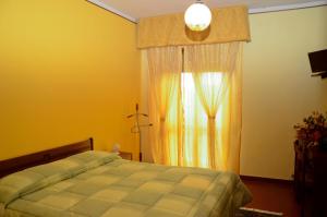 a bedroom with a bed and a window at Hotel Ristorante Il Pino in Chiusi