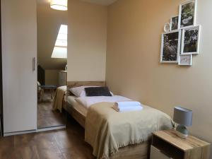 a bedroom with two beds and a mirror at Apartament Silence Triventi Agat in Karpacz