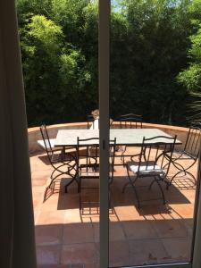a table and chairs sitting on a patio at Villa Louise-Rose in Villeneuve-Loubet