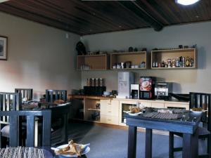 a dining room with two tables and a counter at A La Martha's Air-Port Guest House in Port Elizabeth