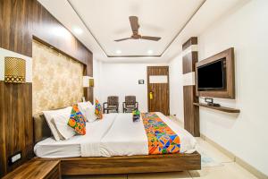 - une chambre avec un lit et une télévision à écran plat dans l'établissement FabHotel Rajnandani Residency Bhawarkua, à Indore