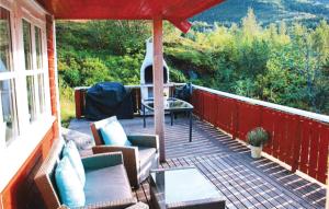 a deck with chairs and a table on a house at Awesome Home In Svolvær With Wifi in Svolvær +12 photos