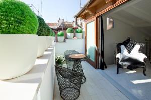 a patio with a table and chairs on a balcony at Casa Fortuny Luxury Apartment in Venice