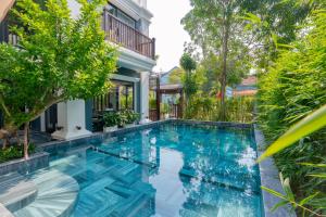 a swimming pool in the backyard of a house at Daisy An Bang Villa in Hoi An