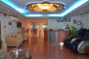 a large living room with a couch and a bar at Al Jazeera Hotel Apartments LLC in Dubai