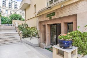 a large blue pot sitting on a table in front of a building at Charming 1BR Apartment In Heart Of Monaco in Monte Carlo